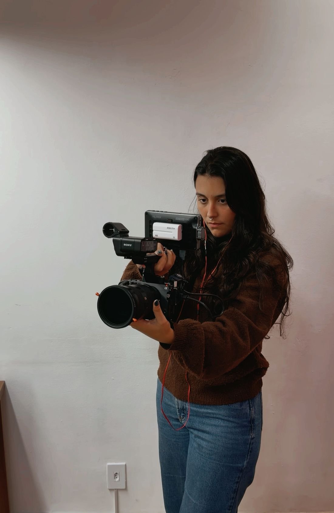 Karol Netuno gravando com câmera profissional